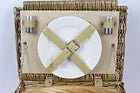 Picnic hamper Wicker summer treats for four people Plates knives forks etc.